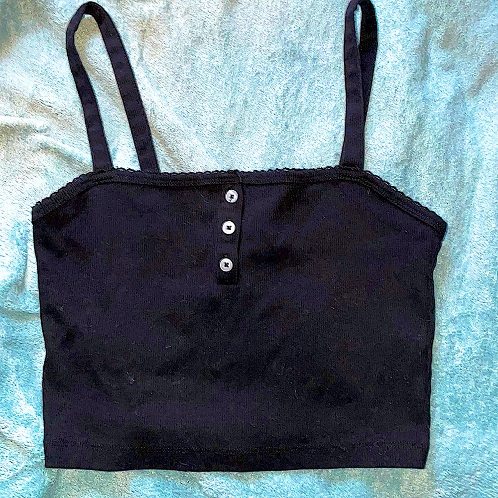 Cute black cropped top, with 3 buttons down the front. Small ruffles on neckline